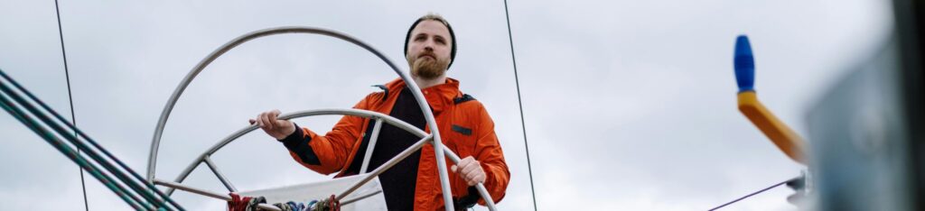 foreign skipper at the helm of a sailing boat in Lorient