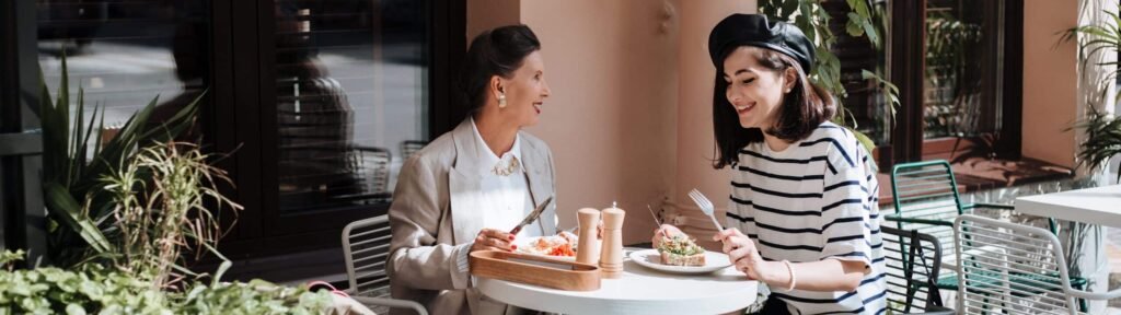 Two women chatting on a café terrace